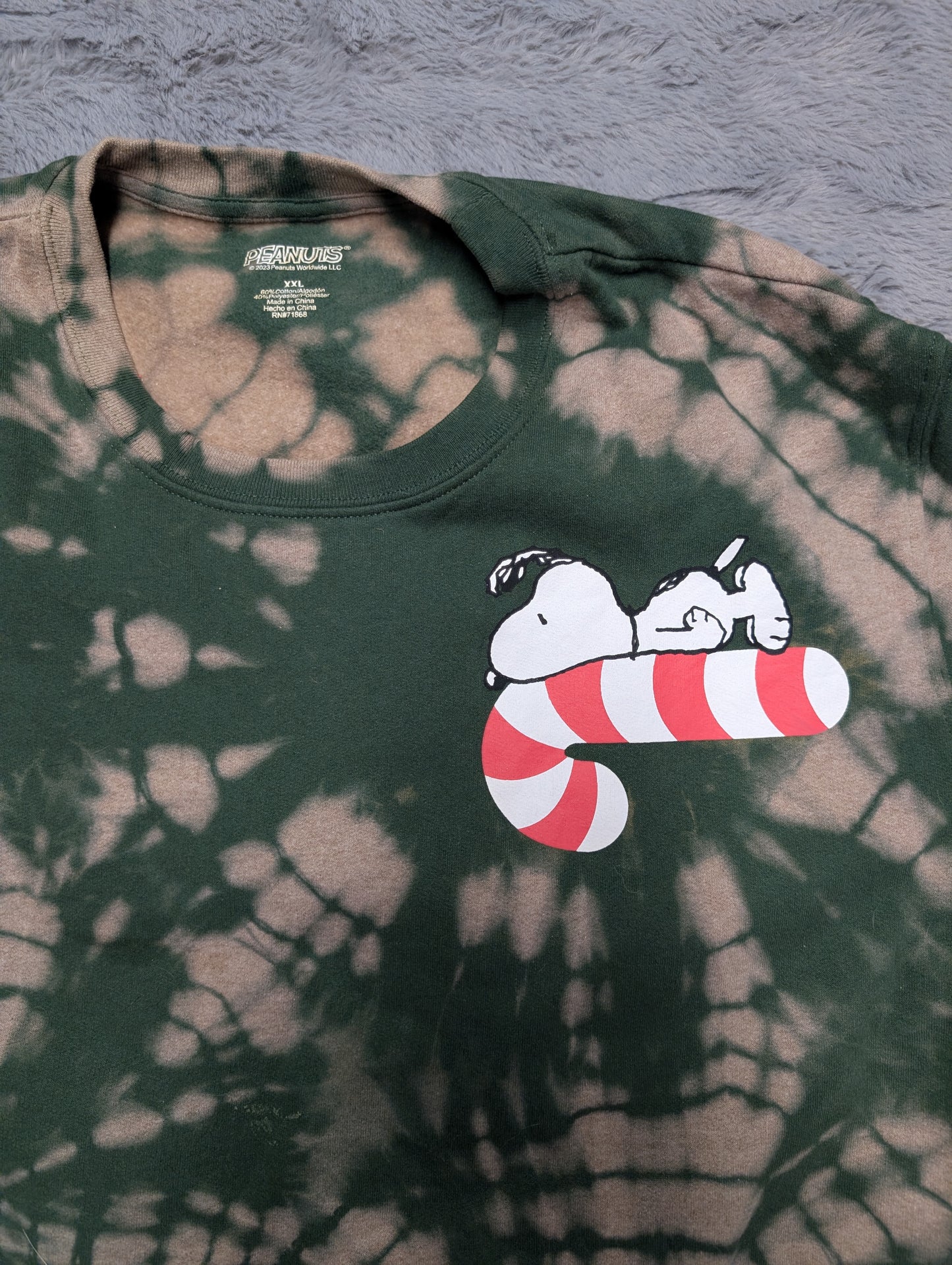 Peanuts Snoopy on a Candy Cane Christmas Reverse Tie-Dye Crewneck Sweatshirt